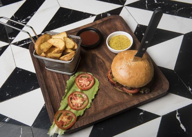 The tenderloin burger was hearty, juicy and meaty, though the bread was a little dry. (Aalok Soni / HT Photo)