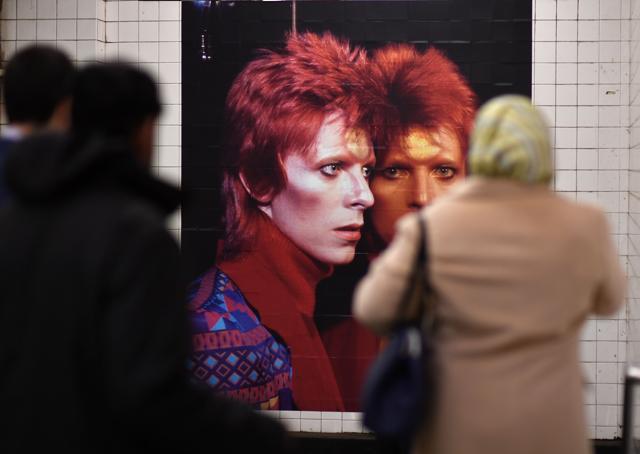 People walk by an David Bowie art installation. (AFP) People walk by an David Bowie art installation. (AFP)