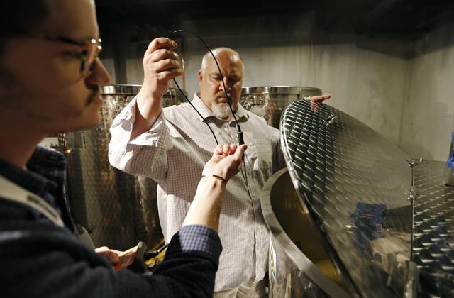 Distillery technician Cole Miller, left, and master distiller in residence George Racz check the temperature of a batch of moonshine cooking. (AP) Distillery technician Cole Miller, left, and master distiller in residence George Racz check the temperature of a batch of moonshine cooking. (AP)