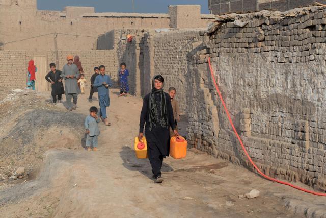 Afghan female labourer Sitara Wafadar collects water near her home in Sultanpur village in Surkh Rod district, in eastern Nangarhar province. (AFP) Afghan female labourer Sitara Wafadar collects water near her home in Sultanpur village in Surkh Rod district, in eastern Nangarhar province. (AFP)