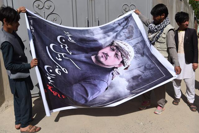 Afghan relatives of Wakil Hussain Allahdad prepare to hang a banner with his picture a day after the attack on a voter registration center, at Wakil's house in Kabul. (Wakil Koshar/ AFP) Afghan relatives of Wakil Hussain Allahdad prepare to hang a banner with his picture a day after the attack on a voter registration center, at Wakil's house in Kabul. (Wakil Koshar/ AFP)