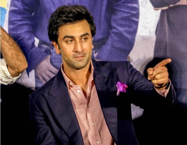 Ranbir Kapoor gesturing towards the media.