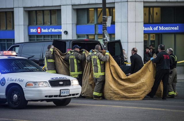 Officials carry a body into a vehicle after a van mounted a sidewalk crashing into pedestrians in Toronto on Monday. (AP) Officials carry a body into a vehicle after a van mounted a sidewalk crashing into pedestrians in Toronto on Monday. (AP)
