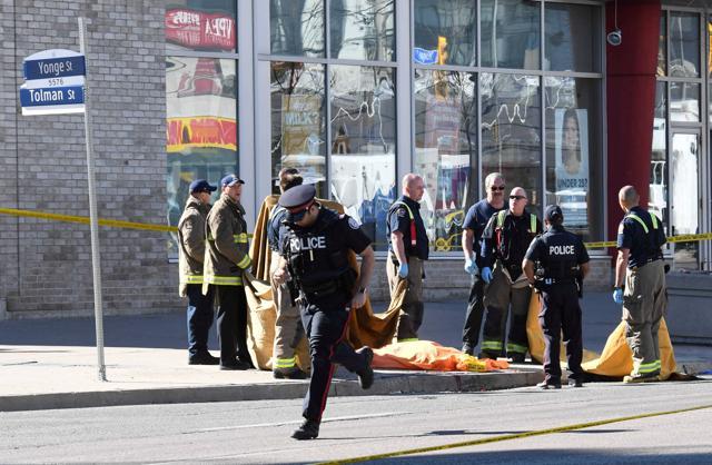 Fire fighters stand near a covered body after the van attack. (Reuters photo) Fire fighters stand near a covered body after the van attack. (Reuters photo)