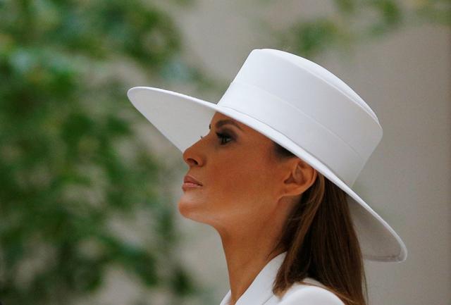 Mrs. Trump wore a stylish belted suit with a broad-brimmed chapeau for her public appearances. (Reuters Photo) Mrs. Trump wore a stylish belted suit with a broad-brimmed chapeau for her public appearances. (Reuters Photo)
