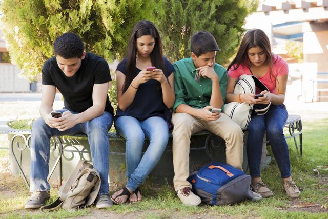 Don’t slouch and peer in your phone. Keep it at eye level instead. (Getty images/iStock) Don’t slouch and peer in your phone. Keep it at eye level instead. (Getty images/iStock)