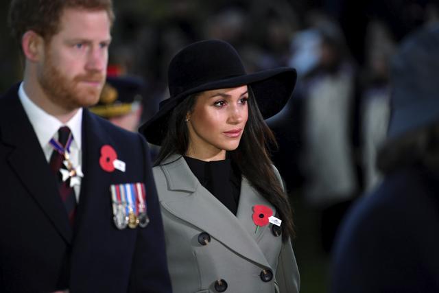 Britain's Prince Harry, left, and his fiancee Meghan Markle attend the Dawn Service at Wellington Arch to commemorate Anzac Day in London, Wednesday. (AP)
