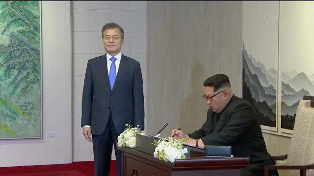 North Korean leader Kim Jong Un signs a guest book as South Korean President Moon Jae-in looks on, at the inter-Korean summit at the truce village of Panmunjom, in this still frame taken from video, South Korea April 27, 2018. (Host Broadcaster via Reuters) North Korean leader Kim Jong Un signs a guest book as South Korean President Moon Jae-in looks on, at the inter-Korean summit at the truce village of Panmunjom, in this still frame taken from video, South Korea April 27, 2018. (Host Broadcaster via Reuters)
