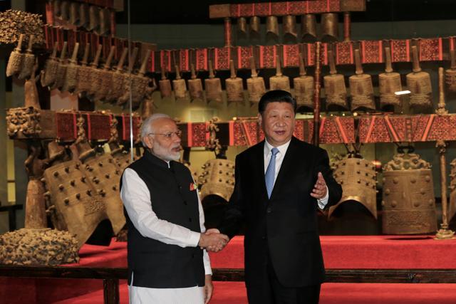Chinese President Xi Jinping and Prime Minister Narendra Modi shake hands as they visit the Hubei Provincial Museum in Wuhan, on Friday. The tour of the museum marked the start of the informal talks between the leaders. (Reuters)