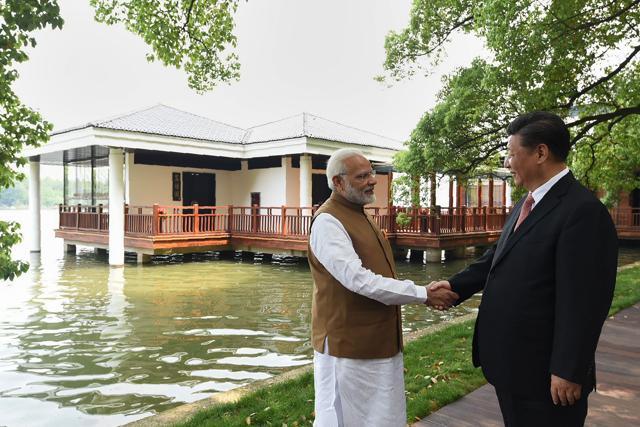 India's Prime Minister Narendra Modi and Chinese President Xi Jinping shaking hands along the East Lake, in Wuhan. (AFP Photo) India's Prime Minister Narendra Modi and Chinese President Xi Jinping shaking hands along the East Lake, in Wuhan. (AFP Photo)