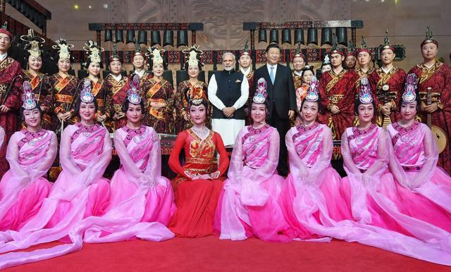 Prime Minister Narendra Modi and Chinese President Xi Jinping pose with folk dancers at the Hubei Provincial Museum, in Wuhan on Friday. (PTI)