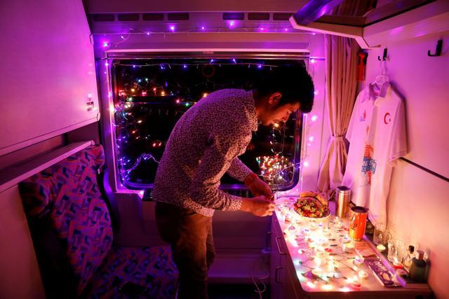 University student Sinan Usta decorates his compartment with candles and lights. (REUTERS) University student Sinan Usta decorates his compartment with candles and lights. (REUTERS)