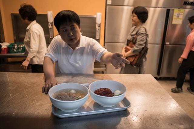 A waiter prepares to serve a 'Pyongyang naengmyeon' a cold noodle dish at the Nampo Myeonok noodle bar restaurant. (AFP) A waiter prepares to serve a 'Pyongyang naengmyeon' a cold noodle dish at the Nampo Myeonok noodle bar restaurant. (AFP)