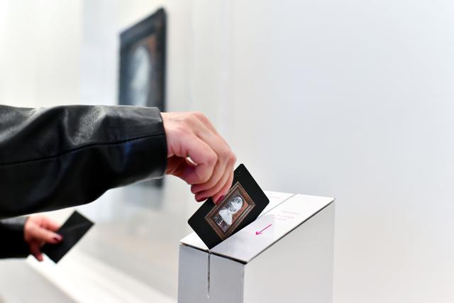 A contributor swipes the card associated with her share of the 1968 work by late Spanish artist Pablo Picasso. (AFP)