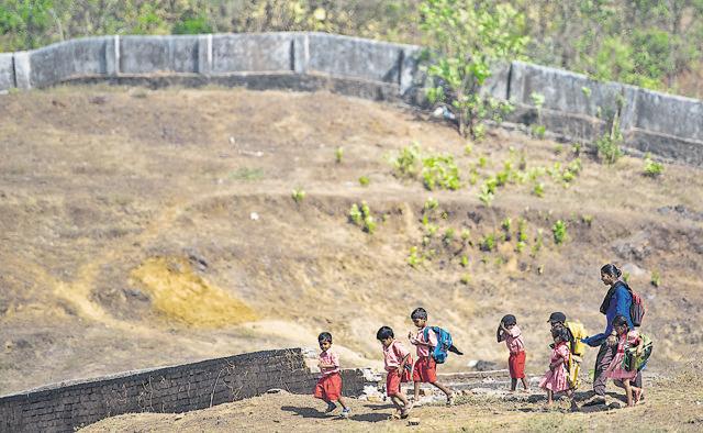 Children make their way to a kindergarten in Thane. (Pratik Chorge/HT Photo) Children make their way to a kindergarten in Thane. (Pratik Chorge/HT Photo)