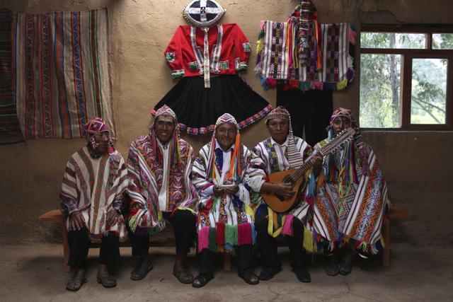 A group of musicians pose for a portrait near Rainbow Mountain where tourists are stunned by the magical beauty of the stripes of turquoise, lavender and gold that blanket the mountain. (AP) A group of musicians pose for a portrait near Rainbow Mountain where tourists are stunned by the magical beauty of the stripes of turquoise, lavender and gold that blanket the mountain. (AP)