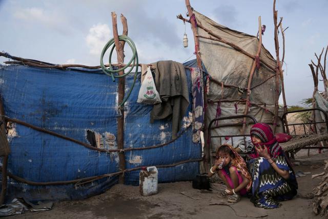 Awsaf, a 5-year-old Yemeni girl, eats bread and drinks tea _ which on many days is the only food she has _ crouching next to her mother in their hut in Abyan, Yemen. (AP) Awsaf, a 5-year-old Yemeni girl, eats bread and drinks tea _ which on many days is the only food she has _ crouching next to her mother in their hut in Abyan, Yemen. (AP)