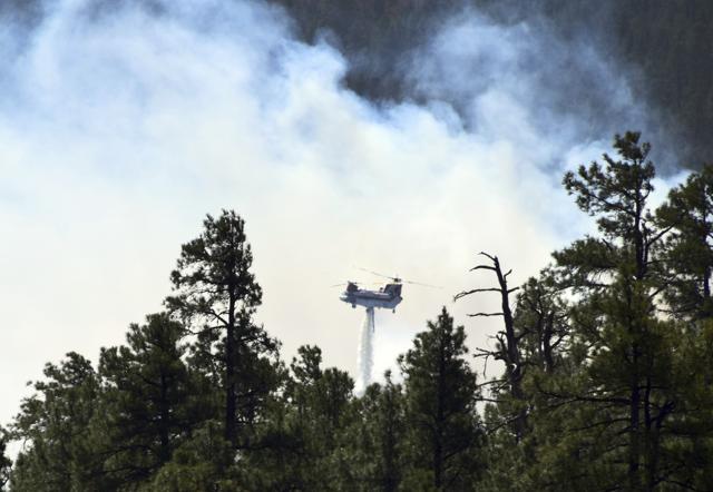 A helicopter fighting a wildfire in north-central Arizona. (AP Photo)