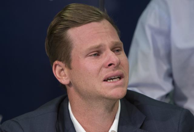 Former Australian cricket captain grimaces as he speaks to the media in Sydney, Thursday, March 29, 2018, after being sent home from South Africa following a ball tampering scandal. Smith and vice-captain David Warner were banned for 12 months while young batsman Cameron Bancroft received 9 months after an investigation into the Australian cricket team's cheating scandal identified Warner as the instigator of the ball tampering plan that unraveled in South Africa. (AP) Former Australian cricket captain grimaces as he speaks to the media in Sydney, Thursday, March 29, 2018, after being sent home from South Africa following a ball tampering scandal. Smith and vice-captain David Warner were banned for 12 months while young batsman Cameron Bancroft received 9 months after an investigation into the Australian cricket team's cheating scandal identified Warner as the instigator of the ball tampering plan that unraveled in South Africa. (AP)
