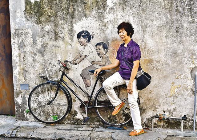 In George Town, this cool street art featuring children riding a bike attracts a large number of tourists (Saubhadra Chatterji)