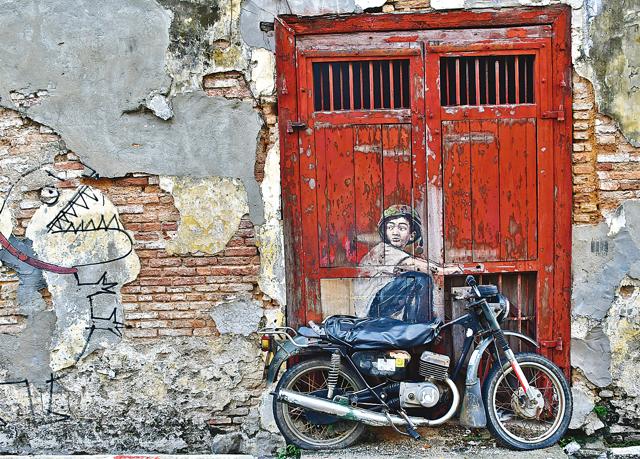 One of the best street arts of George Town is the boy riding a motor bike with a dragon chasing him (Saubhadra Chatterji)