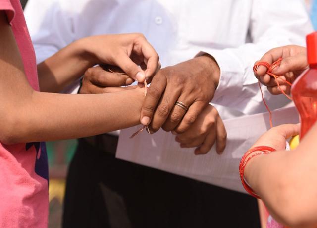 As per rules, a student removes jewellery and sacred threads from her wrist before entering the exam centre at Bal Mandir School in East Delhi. (Raj K Raj/HT Photo) As per rules, a student removes jewellery and sacred threads from her wrist before entering the exam centre at Bal Mandir School in East Delhi. (Raj K Raj/HT Photo)