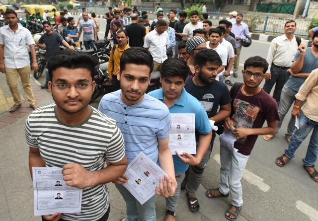 Students hold their admit cards while waiting in line to enter the exam centre at ASN Senior Secondary School in Mayur Vihar, Delhi. (Raj K Raj/HT Photo) Students hold their admit cards while waiting in line to enter the exam centre at ASN Senior Secondary School in Mayur Vihar, Delhi. (Raj K Raj/HT Photo)