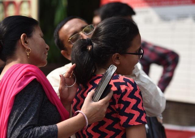A student removes her belt before entering the exam centre to take the NEET exam at Bal Mandir School in New Delhi. (Raj K Raj/HT Photo) A student removes her belt before entering the exam centre to take the NEET exam at Bal Mandir School in New Delhi. (Raj K Raj/HT Photo)