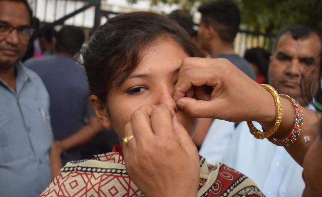A parent removes the nose pin of a student at the Government Model Senior Secondary School exam centre in Sector 23, Chandigarh. (Sikander Singh Chopra/HT Photo)