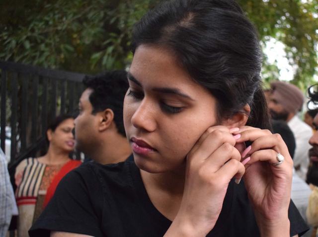 A student removes her earrings before entering the Government Model Senior Secondary School NEET exam centre in Sector 23, Chandigarh. (Sikander Singh Chopra/HT Photo)