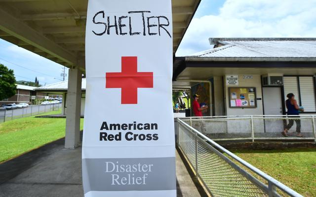 Evacuees carry supplies offered at the Pahoa Community Center in Pahoa on Hawaii's Big Island. (AFP Photo)