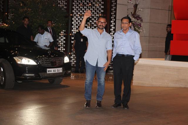 Bollywood superstar Aamir Khan waves to the crowd while attending Isha Ambani’s enegagement party in Mumbai. (Viral Bhayani)