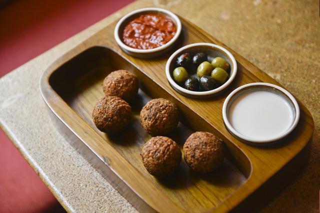 The feta and pine nut-stuffed falafel balls are perfect, crunchy on the outside and fluffy and flavourful on the inside. (Aalok Soni / HT Photo)
