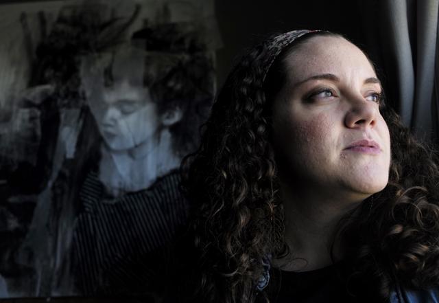 MacLure sits with a self-portrait titled "The Old Me," created from charcoal and tracing paper on paper. (AP) MacLure sits with a self-portrait titled "The Old Me," created from charcoal and tracing paper on paper. (AP)