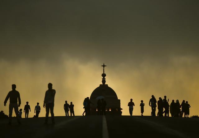 People at Raisina Hills in New Delhi as the weather took a turn on Sunday. (PTI Photo) People at Raisina Hills in New Delhi as the weather took a turn on Sunday. (PTI Photo)