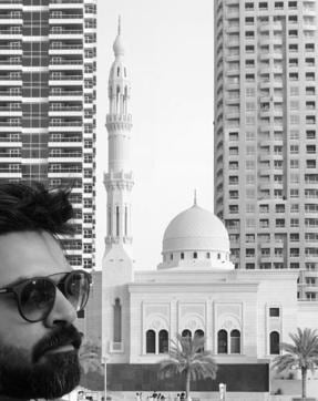 A still ofSimbu with the Dubai skyline behind him. (Santoshsivan/Twitter) A still ofSimbu with the Dubai skyline behind him. (Santoshsivan/Twitter)