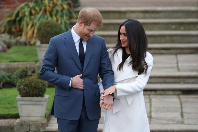 (FILES) In this file photo taken on November 27, 2017 Britain's Prince Harry stands with his fiancée US actress Meghan Markle as she shows off her engagement ring whilst they pose for a photograph in the Sunken Garden at Kensington Palace in west London, following the announcement of their engagement. (AFP) (FILES) In this file photo taken on November 27, 2017 Britain's Prince Harry stands with his fiancée US actress Meghan Markle as she shows off her engagement ring whilst they pose for a photograph in the Sunken Garden at Kensington Palace in west London, following the announcement of their engagement. (AFP)