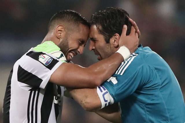 Juventus' defender from Italy Medhi Benatia (L) celebrates with Gianluigi Buffon after winning the Italian Cup (Coppa Italia) vs AC Milan at the Olympic stadium on May 9, 2018 in Rome. (AFP) Juventus' defender from Italy Medhi Benatia (L) celebrates with Gianluigi Buffon after winning the Italian Cup (Coppa Italia) vs AC Milan at the Olympic stadium on May 9, 2018 in Rome. (AFP)
