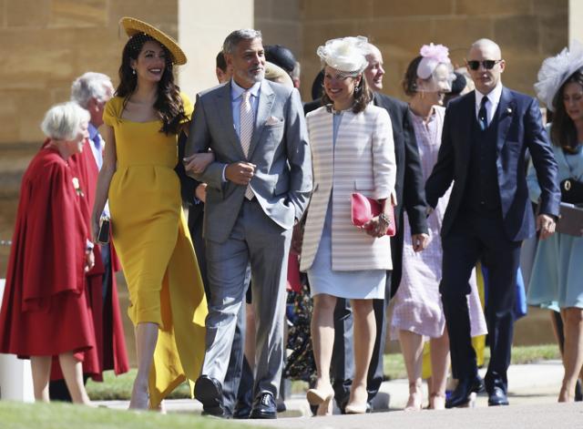 Amal Clooney, left, George Clooney, second left, and Tom Hardy, right, arrive for the wedding ceremony of Prince Harry and Meghan Markle at St. Georges Chapel in Windsor Castle in Windsor. (AP) Amal Clooney, left, George Clooney, second left, and Tom Hardy, right, arrive for the wedding ceremony of Prince Harry and Meghan Markle at St. Georges Chapel in Windsor Castle in Windsor. (AP)