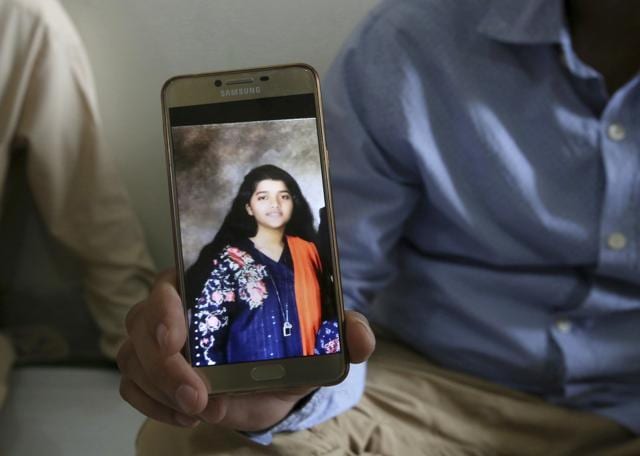 Abdul Aziz Sheikh, center, father of Sabika Sheikh, a victim of a shooting at a Texas high school, shows a picture of his daughter in Karachi, Pakistan, Saturday, May 19, 2018. (AP) Abdul Aziz Sheikh, center, father of Sabika Sheikh, a victim of a shooting at a Texas high school, shows a picture of his daughter in Karachi, Pakistan, Saturday, May 19, 2018. (AP)