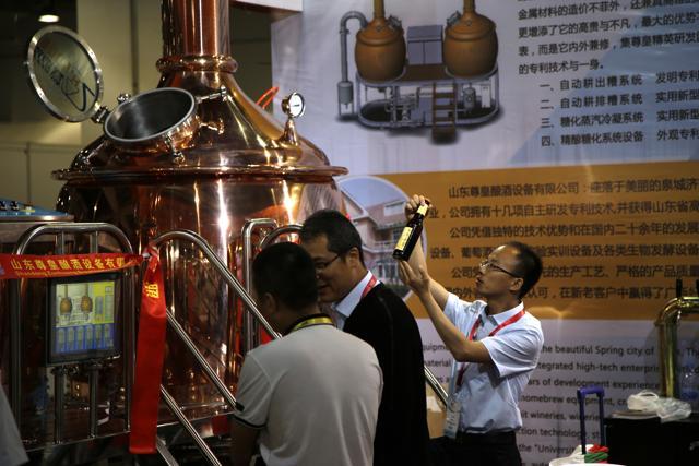 A man reads a beer label next to a copper brewing machine at the 2018 Craft Beer of China Exhibition in Shanghai. (AP) A man reads a beer label next to a copper brewing machine at the 2018 Craft Beer of China Exhibition in Shanghai. (AP)