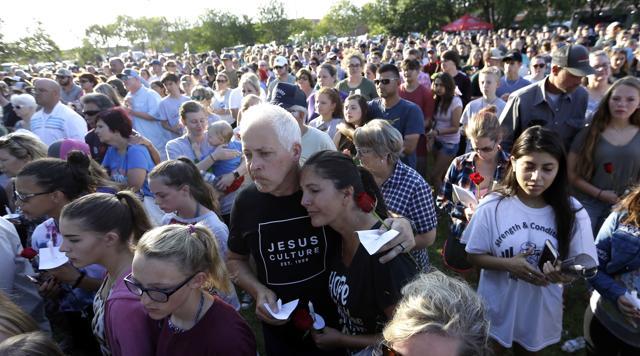 Mourners gather during a prayer vigil following a shooting at Santa Fe High School in Santa Fe, Texas, on Friday, May 18, 2018. (AP) Mourners gather during a prayer vigil following a shooting at Santa Fe High School in Santa Fe, Texas, on Friday, May 18, 2018. (AP)
