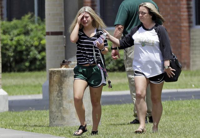 A student, left, reacts after retrieving her belongings inside Santa Fe High School in Santa Fe, Texas, on Saturday, May 19, 2018. (AP)