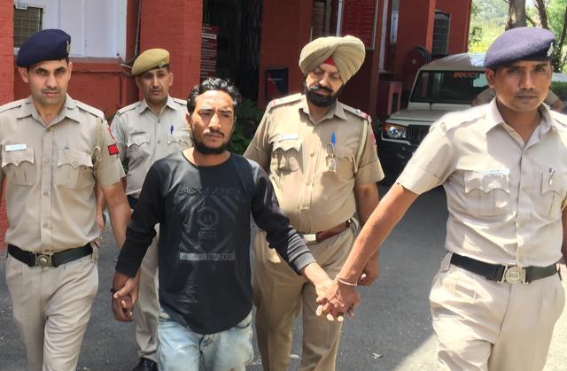 Accused Mukesh, 26, in police custody in Sector 36 on Sunday. He was later sent to judicial custody. (HT Photo)