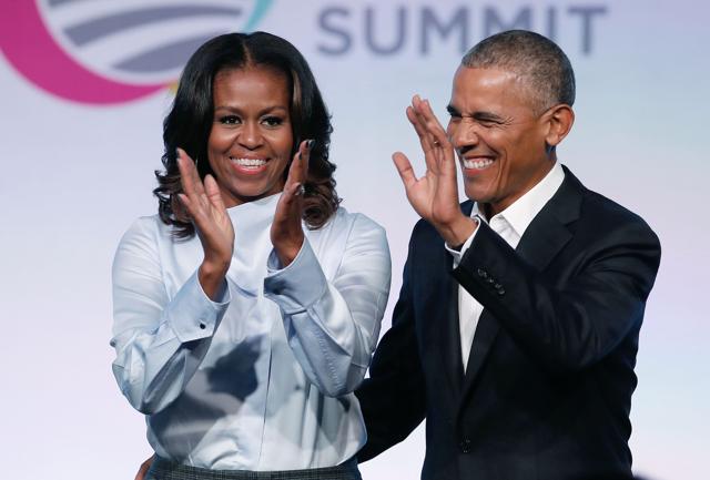 In this file photo taken on October 31, 2017, former US President Barack Obama and First Lady Michelle Obama arrive at the Obama Foundation Summit in Chicago, Illinois. (AFP) In this file photo taken on October 31, 2017, former US President Barack Obama and First Lady Michelle Obama arrive at the Obama Foundation Summit in Chicago, Illinois. (AFP)