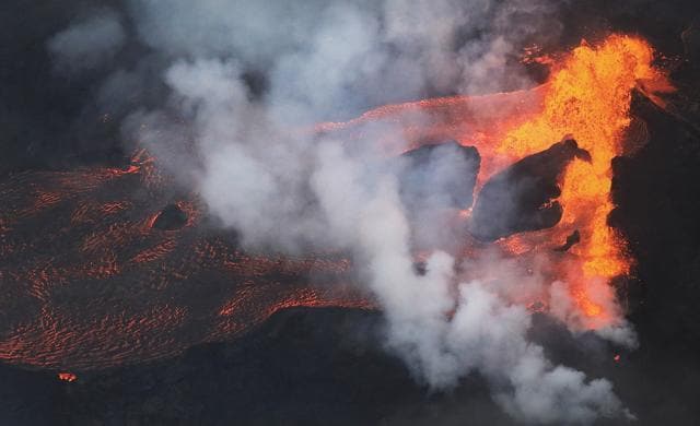 Lava erupts and flows from the Kilauea Volcanic Fissure, toward the Pacific Ocean, on the Big Island of Hawaii, near Pahoa, Hawaii, on May 21, 2018.  (AFP)