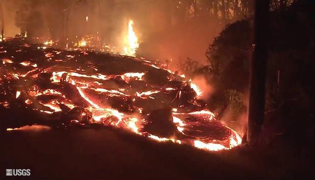 Lava flowing onto Kaupili Street in the Leilani Estates area near Pahoa on the island of Hawaii in the early morning hours of Friday. (AP) Lava flowing onto Kaupili Street in the Leilani Estates area near Pahoa on the island of Hawaii in the early morning hours of Friday. (AP)