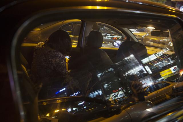 Khyati Malhotra uses her phone in the back seat of her car. (Photographer: Ruhani Kaur/Bloomberg) Khyati Malhotra uses her phone in the back seat of her car. (Photographer: Ruhani Kaur/Bloomberg)