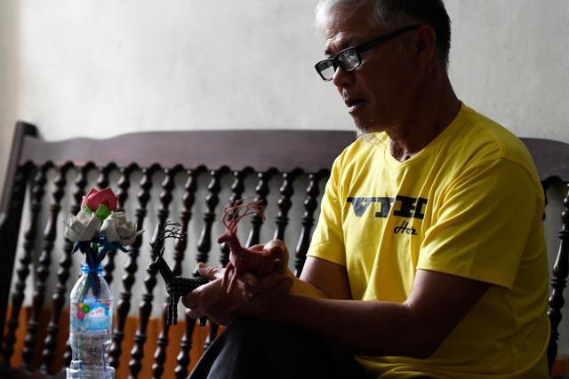 Nguyen Truong Chinh displaying intricately crafted animals made from plastic bags by his son and death row inmate Nguyen Van Chuong. (AFP) Nguyen Truong Chinh displaying intricately crafted animals made from plastic bags by his son and death row inmate Nguyen Van Chuong. (AFP)