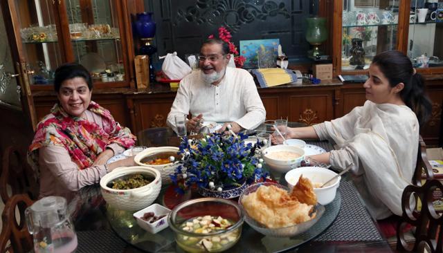 Dr Mohsin Wali with his family during Sehri. On the table are food items like dates, khajla, sewaiyan and fresh fruits. (Amal KS/HT)